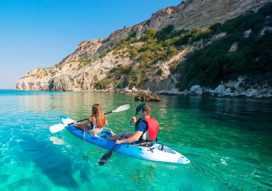 Man and woman paddling on a kayak in a lake