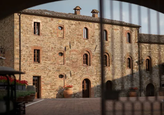 Exterior view of stone building with a stone patio in front