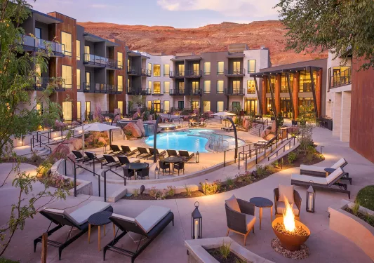 Exterior view of hotel building with balconies looking towards and outdoor pool