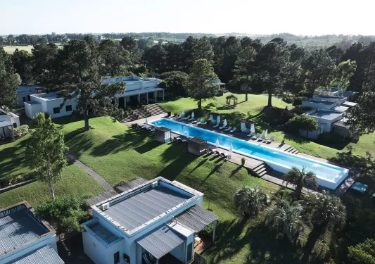 Exterior, sky view of hotel complex surrounded by trees