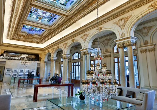Hotel lobby with couches and a low-hanging chandelier