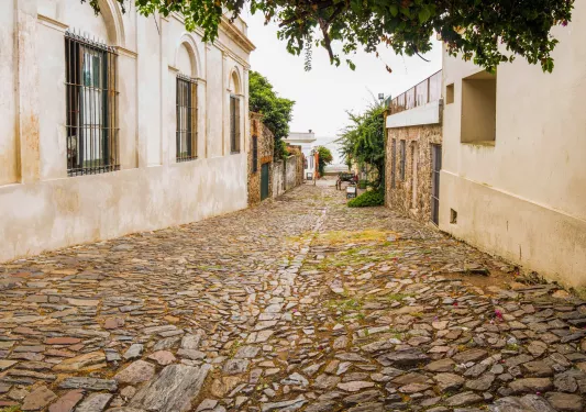 Alleyway with a stone pathway and stone buildings on either side