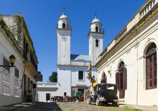Stone pathway leading to a large, white church building