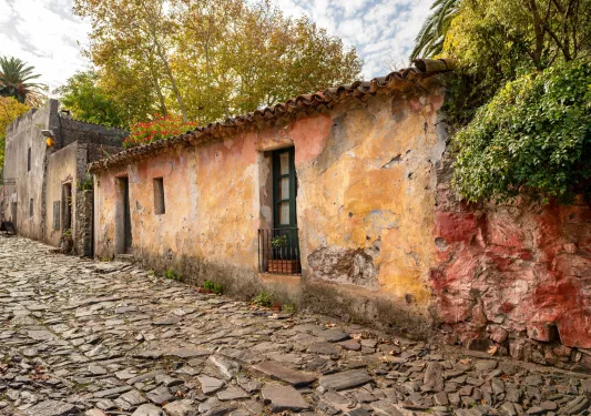 Stone alleyway with an older stone, yellow building to the right