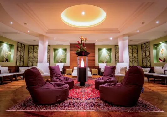 Seating and lounge area with cushioned bean bags and a centerpiece with a flower