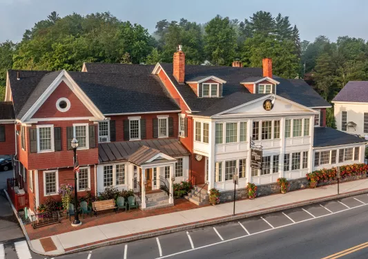 Exterior view of red and white building with plants in front