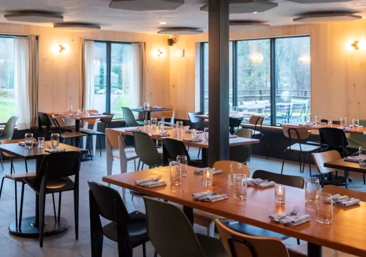 Restaurant dining hall with wooden tables and colorful chairs
