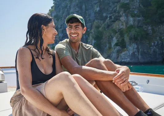 Two guests sit and smile at each other