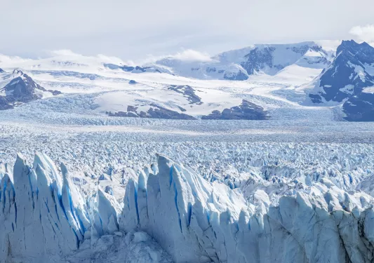 Snow caps and glaciers with mountains in the distance