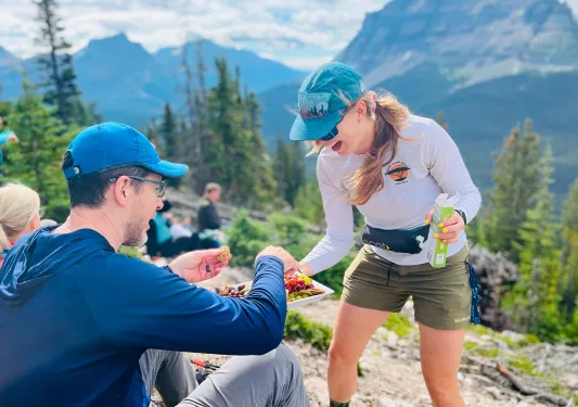 Woman passing a plate of snacks to a man