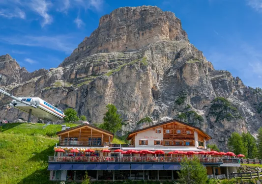 Wooden cabin building with a large mountain in the back