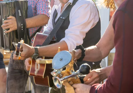 Group of men playing instruments while laughing and smiling