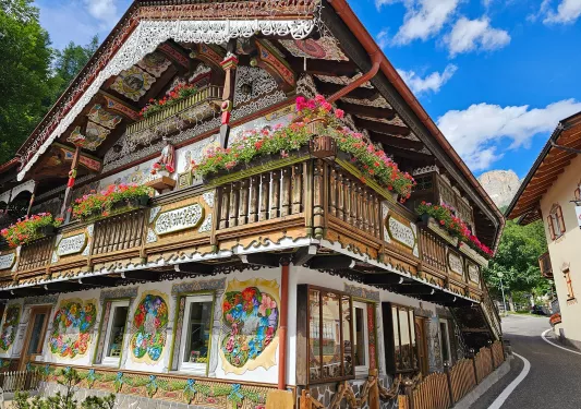 Two-story, wooden building with drawings on the exterior