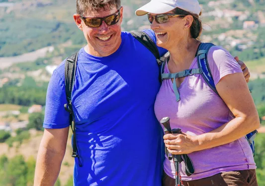 Man and woman smiling and leaning into each other