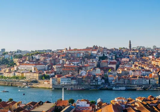 Sky view of a town with a large river in front