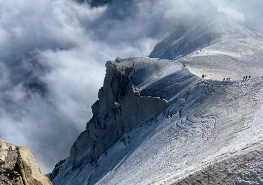 Large mountains surrounded by foggy clouds
