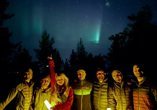 Group of people holding lanterns under the night sky