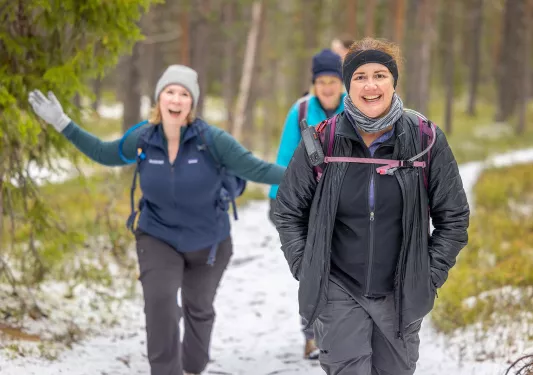 Group of women walking along a snowy trail