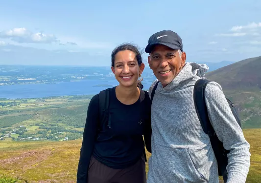 Man and woman smiling with a large valley in the background