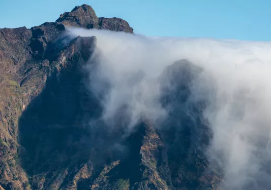 Large mountain covered in fog
