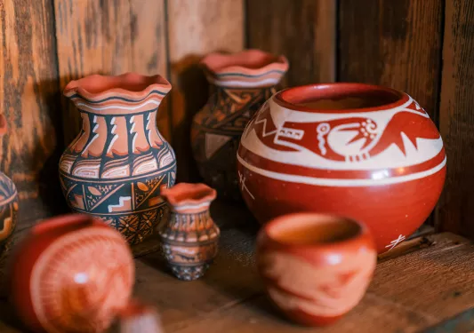 Clay, orange pots with art drawn on them
