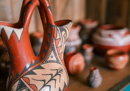 Clay pots and cups on a wooden table