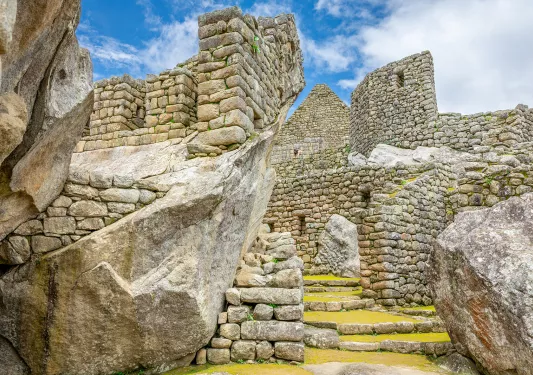 Stone ruins of an ancient town, with stone steps covered with grass