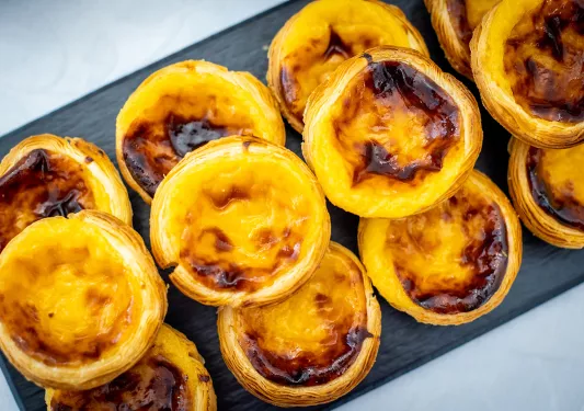 Custard pastries on a black plank