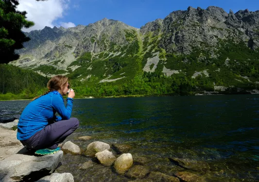 Backroads guest sits by a lake