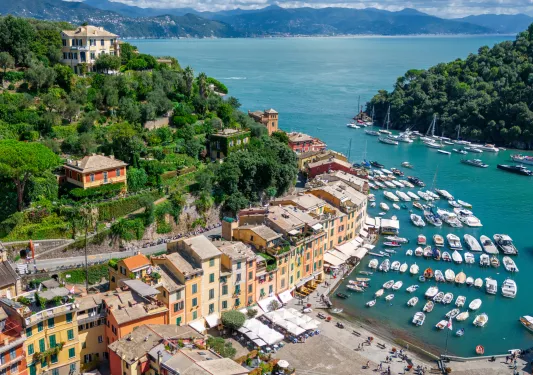 Sky view of a row of buildings in front of a boat dock
