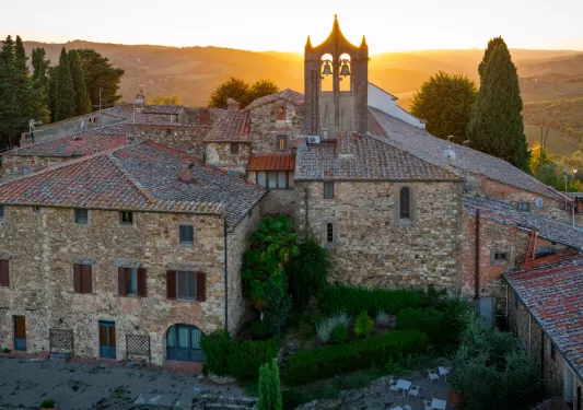Exterior view of stone castle-like building with the sunset in the background