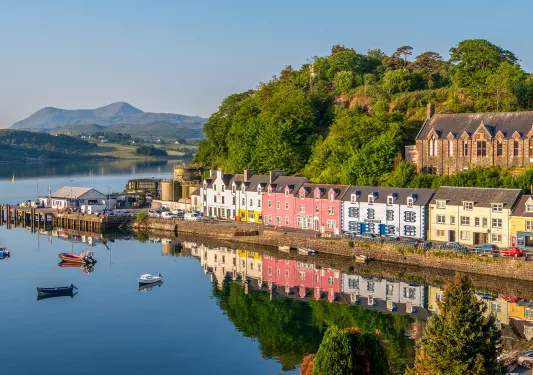 Row of colorful houses along an ocean dock, with boats in the water