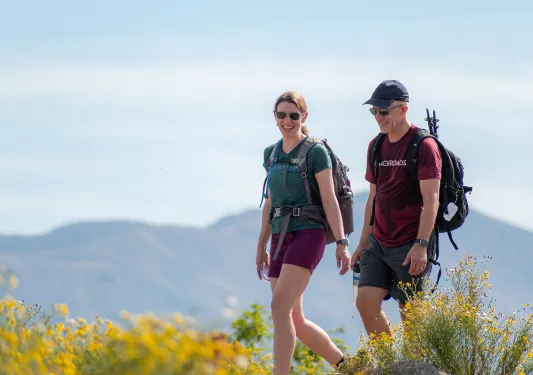 Backroads guests on a hike through a grassy area