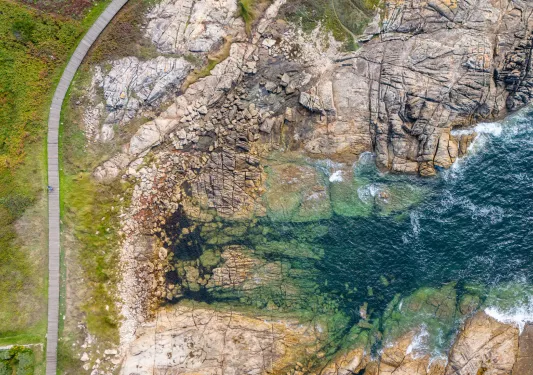 Sky view of ocean and large cliffs