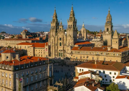Exterior view of large castle-like building in the middle of a town square