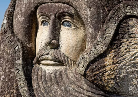 Stone sculpture of an older adventurer