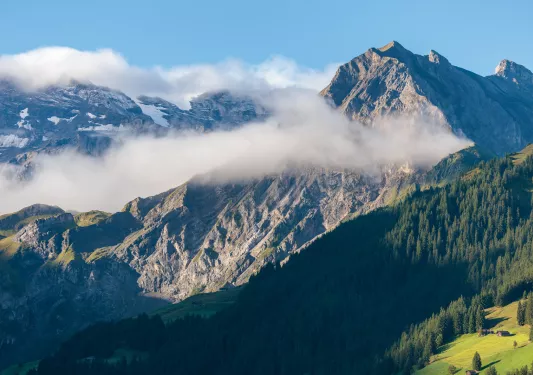mountain with clouds flying by