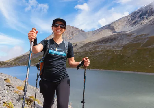 Hiker walking next to a lake