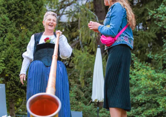 Backroads guests learns about instrument from local