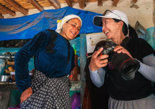 Woman showing another woman a photo on a camera
