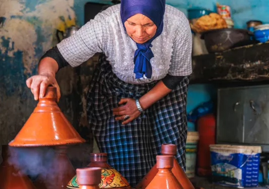 woman uncovering plates of food