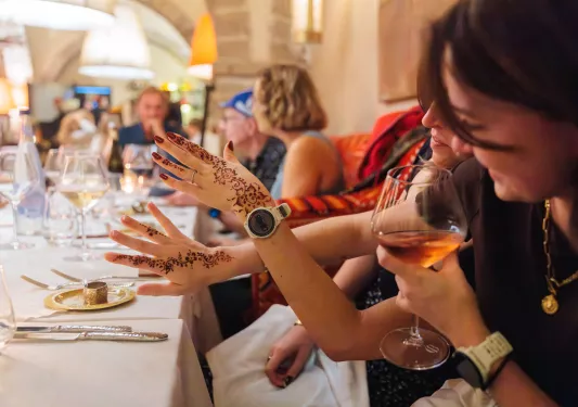 Woman showing henna tattoos on her arms and hands
