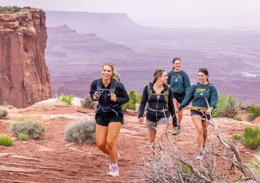 A group of four backroads guest hike in the desert