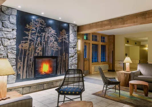 Hotel Lobby with cushioned chairs in front of a stone fireplace