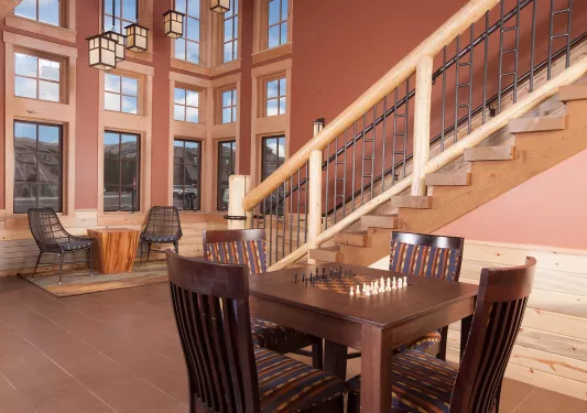 Outdoor patio with tables and a chess set in the center