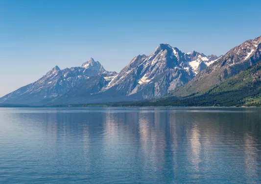 Large lake with tall, snow-capped mountains in the distance
