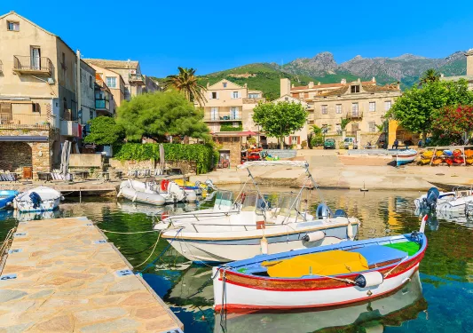 Boats docked by a small coastal town