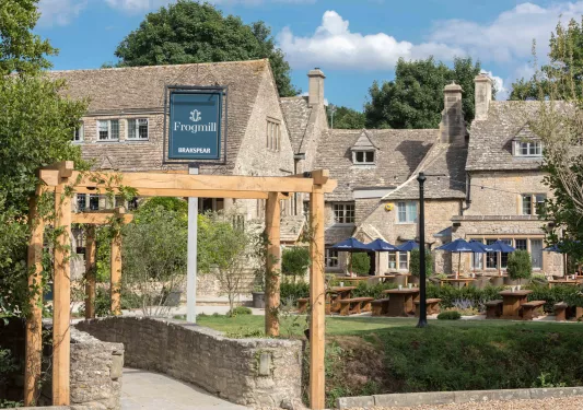 Exterior view of stone and brick building with an outdoor patio