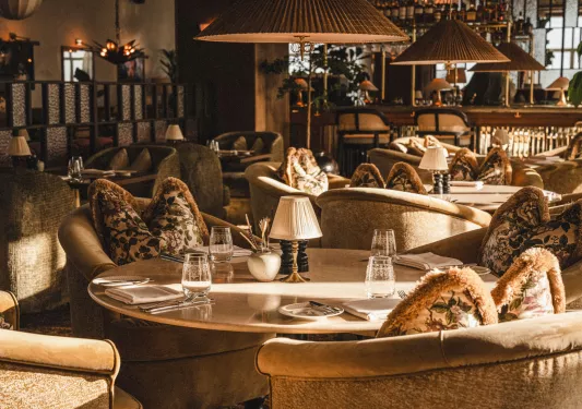 Indoor lounge with cushioned couches with circular tables