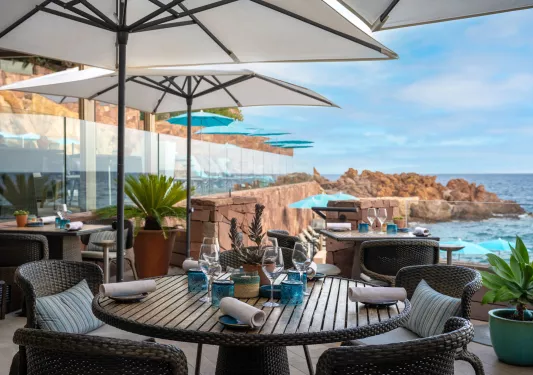 Outdoor patio with tables and views of the ocean
